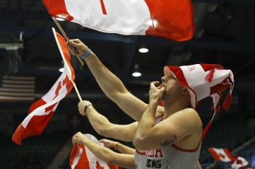 Team Canada fans wave Canadian flags at the Ford World Women's Curling Championship March 19, 2014 in Saint John, Canada (Photo: Jamie Roach / Shutterstock)
